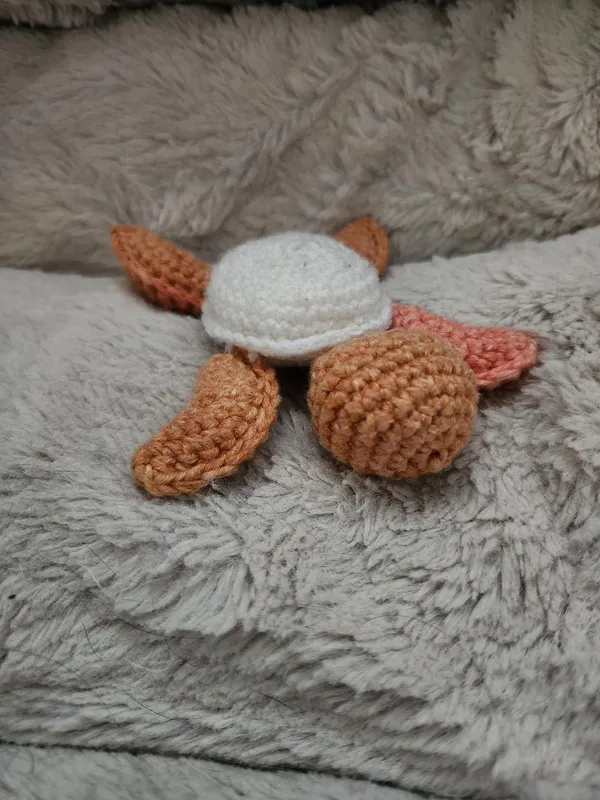 Orange crochet turtle.